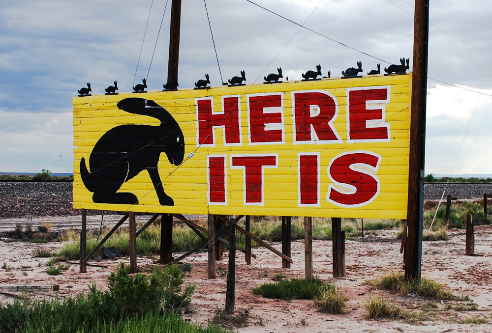 photograph of Jack Rabbit Trading Post sign that reads "Here it is"